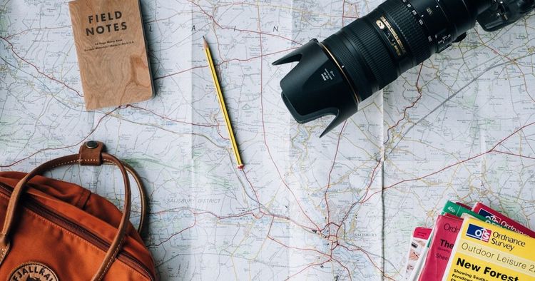 World map with passports and travel items - travel planning for Dutch passport holders abroad